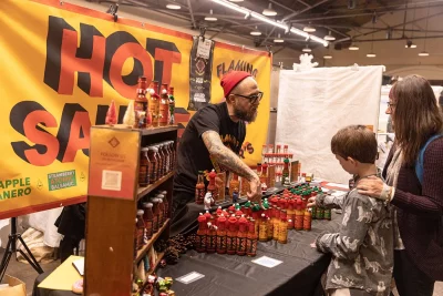 The Flaming Homer's Hot Sauce booth giving out samples to the public