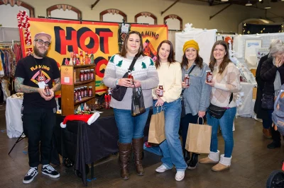 Kallie Sekolich, Ronnie Robinson, Tanna Fraga, and Katey Brown outside Flaming Homer's Hot Sauce booth.