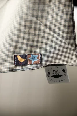A How Do I Flower? handkerchief with two small patches sewn near the tag.