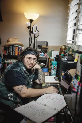 Abe Francis sits at his desk.