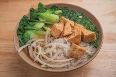 A bowl of tofu and Bok Choy pho.
