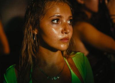 A woman at a party stares into the distance.