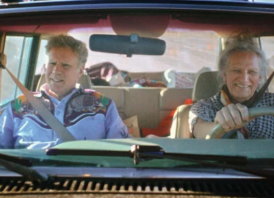 Will Ferrell and Harper Steele sit in the front seat of a car together.