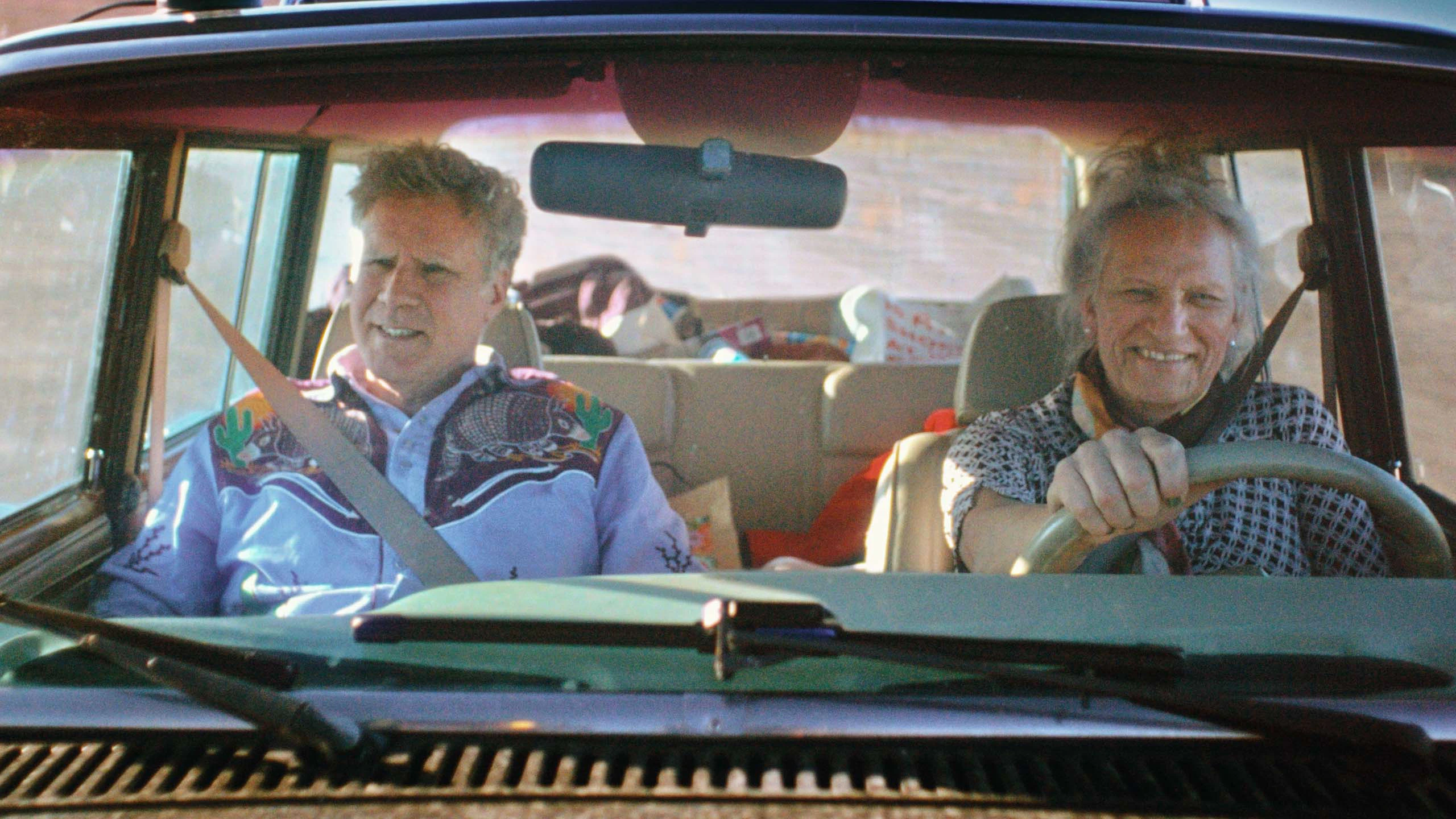 Will Ferrell and Harper Steele sit in the front seat of a car together.