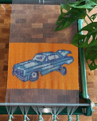 An image of a blue lowrider woven out of beads