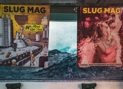 Past SLUG Mag covers hung on the walls.