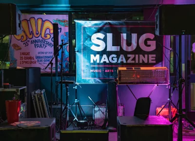 SLUG signage set the mood on the small Blue Gene's stage.