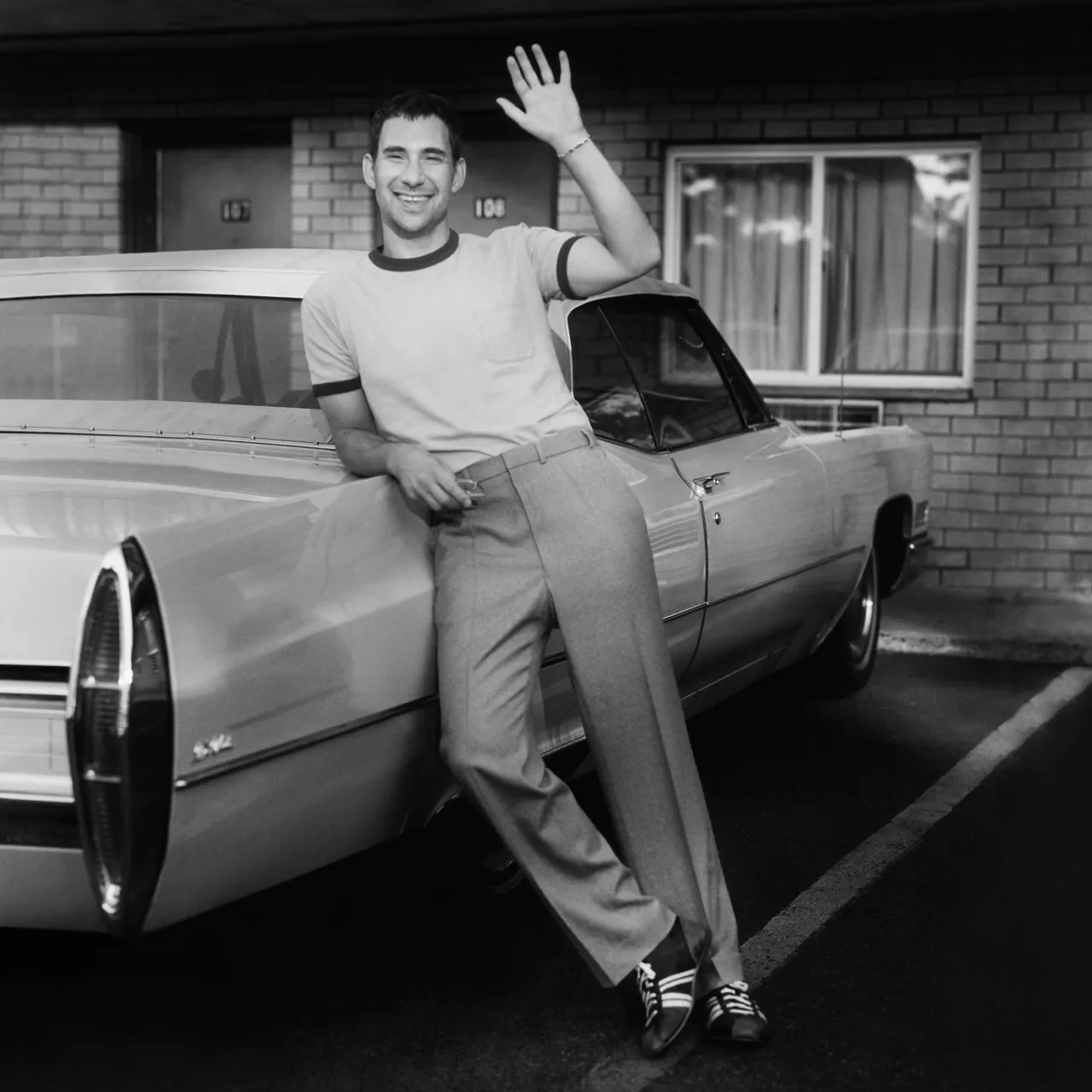Bleachers' album cover is a man leaning against a car in black and white.