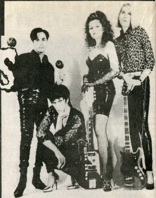 Four people posing for a photo together.