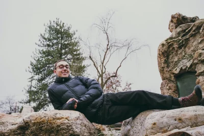 Scott Lippitt lays on top of rocks.