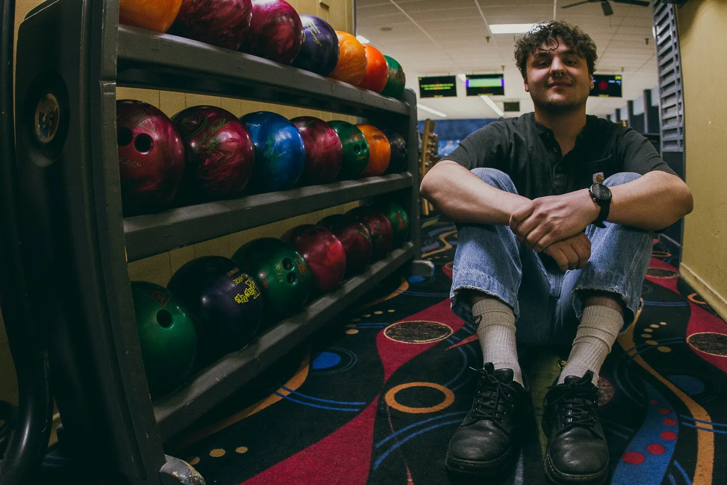 Sean sitting in a bowling alley.