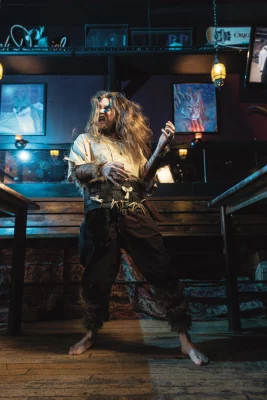 BerserkAir flips his hair while playing air guitar. 