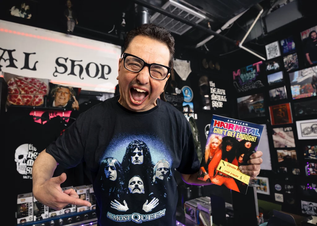 Steven Blush points at his book excitedly inside The Heavy Metal Shop.