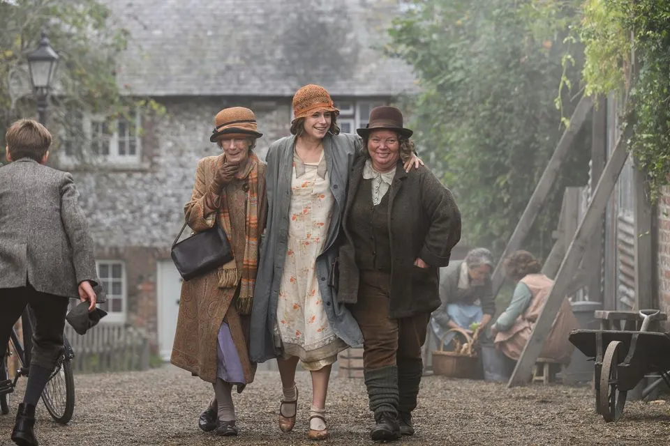 3 Women in an English Village during the 1920's walk down a dirt road.