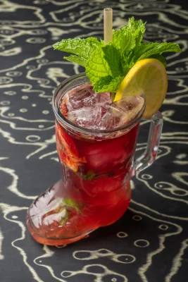 A sangria cocktail in a boot-shaped glass at Italian restaurant Cosmica.
