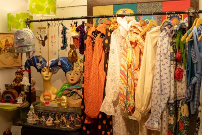 A collection of vintage fashion items on a rack at the shop Unhinged.