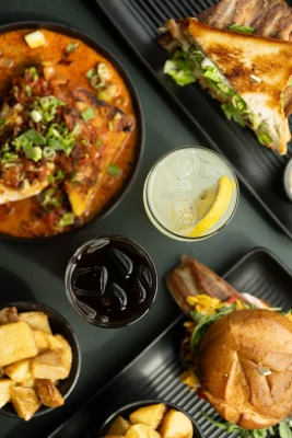 A table full of food and drinks at the restaurant Goat Head in Salt Lake City.