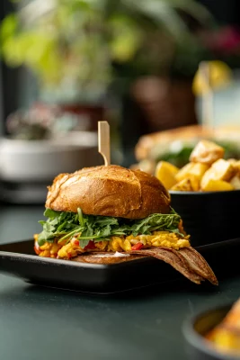 A sandwich on a platter with sides at Goat Head the restaurant in Salt Lake City.
