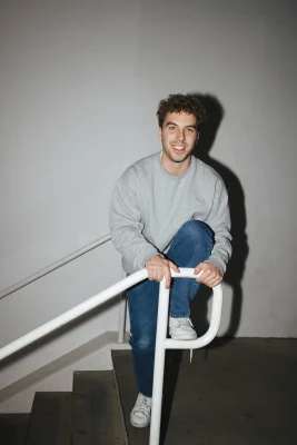 A man climbing over a railing.