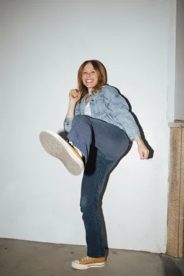 A woman karate-kicking.