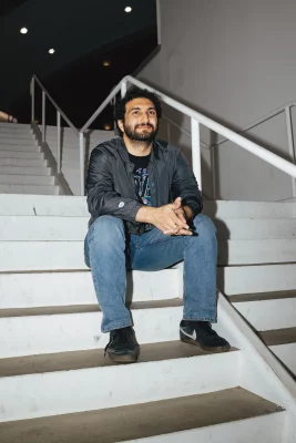 A man sitting on the step of a staircase.