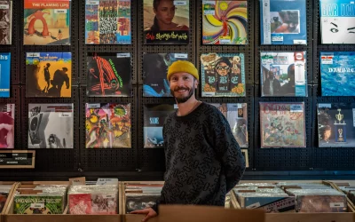 DJ Matthew Fit infront of a wall of records at FOUNTAIN Re