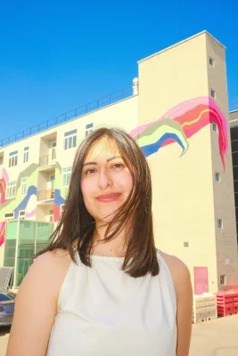 Nancy Rivera standing in front of the Norbridge building.