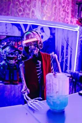 A skeleton dressed like he's from the future serving drinks.