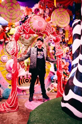 A man standing in a homemade wonderland.