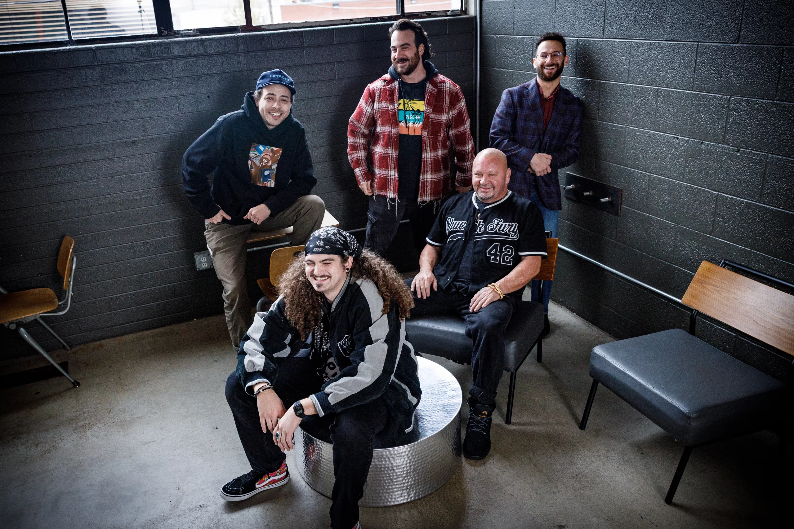 A group of comedians in a darkened room.