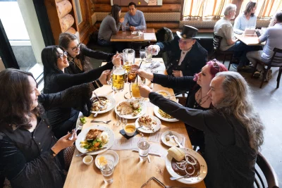 the goth ethnic food group clinking glasses across the table