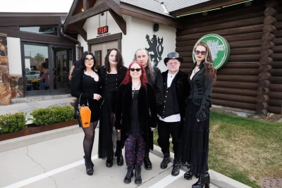 The goth ethnic food group standing outside the restaurant