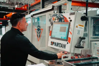 Ricardo Pazos sitting at a computer in the granite facility