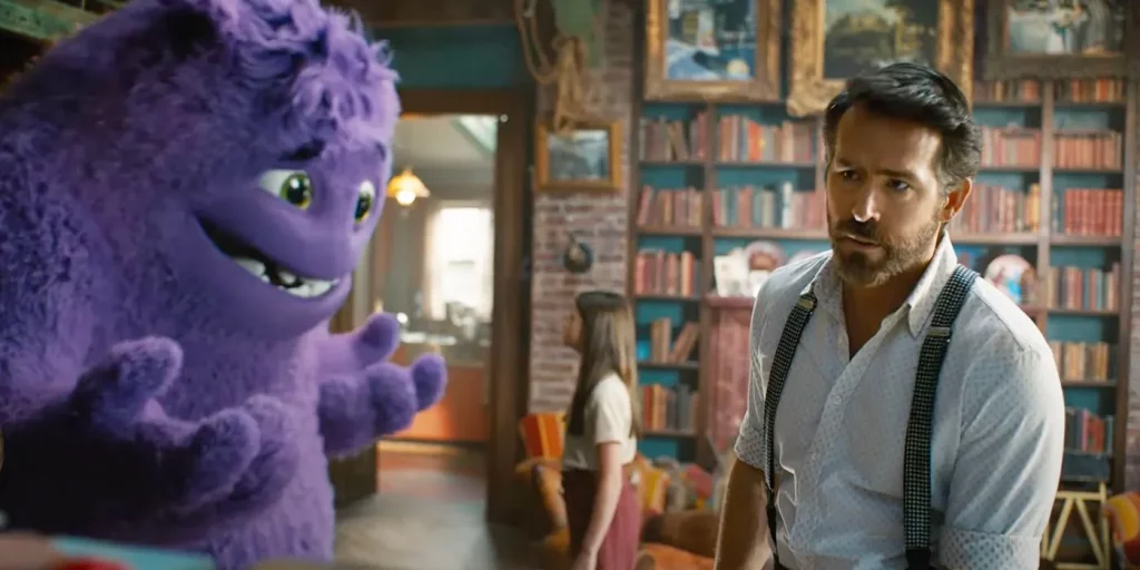 A giant purple furry created looks at a young girl in the background. A man in suspenders looks at someone off screen in the foreground. They all stand in a library.