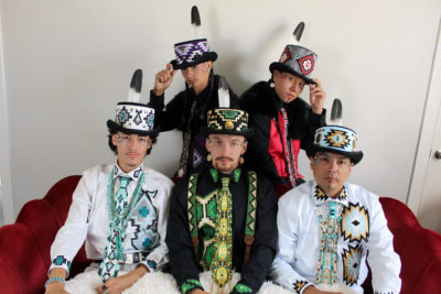 Five Indigenous models wearing outfits designed by Codijo Chebon Yazzie.