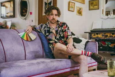 Peter sitting on a lavender couch.