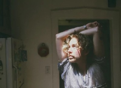 Sun shining on Peter's face as he looks off to the left side.