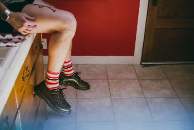 Feet dangling off the side of a counter.
