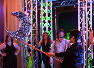 The audience engages with a Piñata during intermission, with Jax Creative taking a turn with the bat.