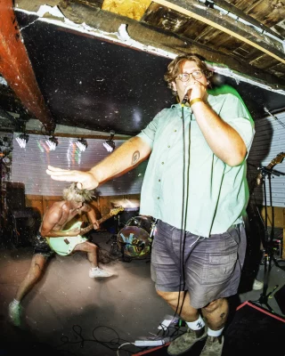 Backhand's singer Ben Owens at the mic. @mitchy.quick shredding in the background at Had A Great Summer (H.A.G.S.) Festival at Salt Lake City