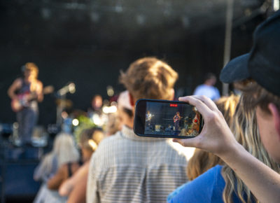 A photo taken through an audience members phone of The Moss