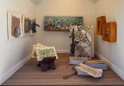 The inside of the helper mini-showing the art of Maya Lalvani in The Helper Mini Museum 