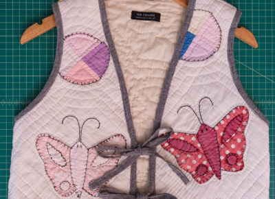 A quilt vest sits on a work table