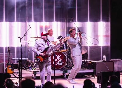 OK Go playing on stage just after sunset at the outdoor venue the Red Butte Garden Amphitheatre in Salt Lake City, UT.