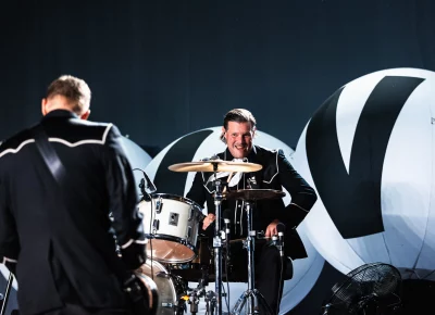 Drummer Christian Grahn of The Hives eyes Guitarist Niklas Almqvist facing towards him as they both play on stage at The Union Event Center in Salt Lake City.