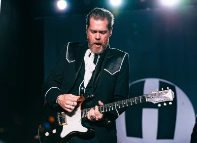 Guitarist Vigilante Carlstroem playing with The Hives on stage at the Union Event Center.