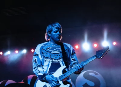 Snõõper guitarist Connor Cummins dead center with lights behind, playing on stage playing support before the Hives in Salt Lake City.