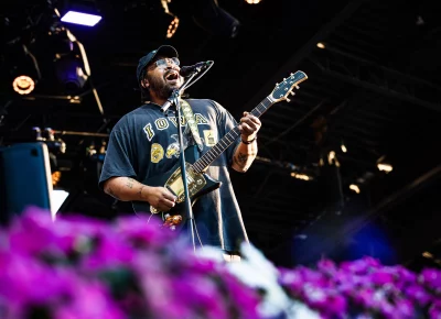 Bartees Strange singing and playing guitar while on stage in Salt Lake City, UT, providing an opening set with OK Go.