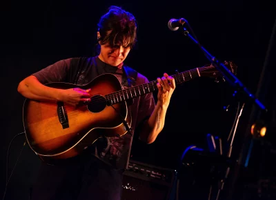 Adrianne Lenker plays guitar on stage at Library Square for SLC Twilight.