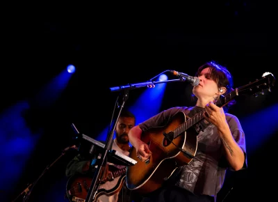 Adrianne Lenker of Big Thief sings while playing guitar on stage at Library Square for SLC Twilight.